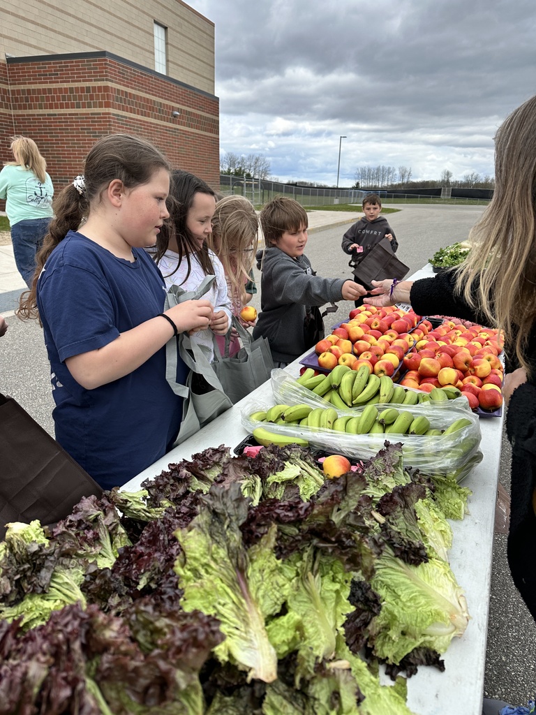 Students pick out fresh vegetables from the school farmers market.