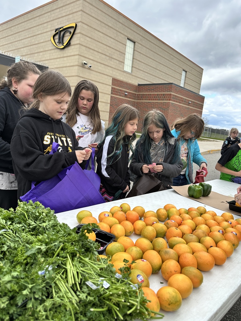 Students pick out fresh vegetables from the school farmers market.