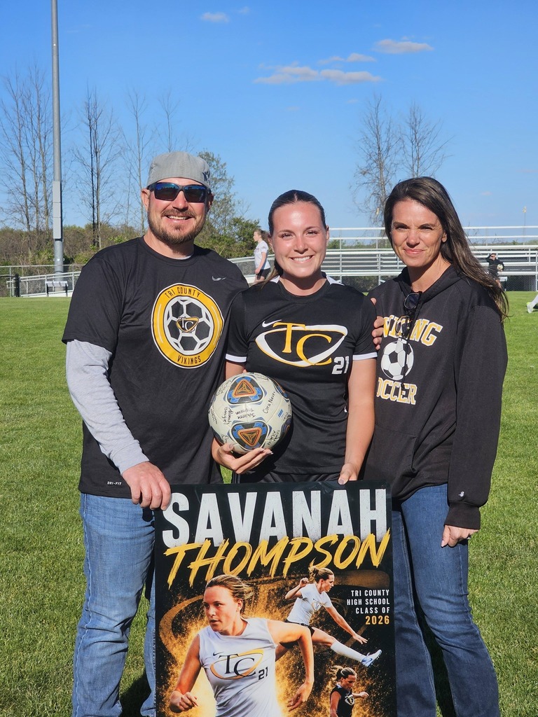 Athlete, Savanah Thompson along with her parents pose for a photo celebrating breaking the MHSAA record for most goals scored in a career.