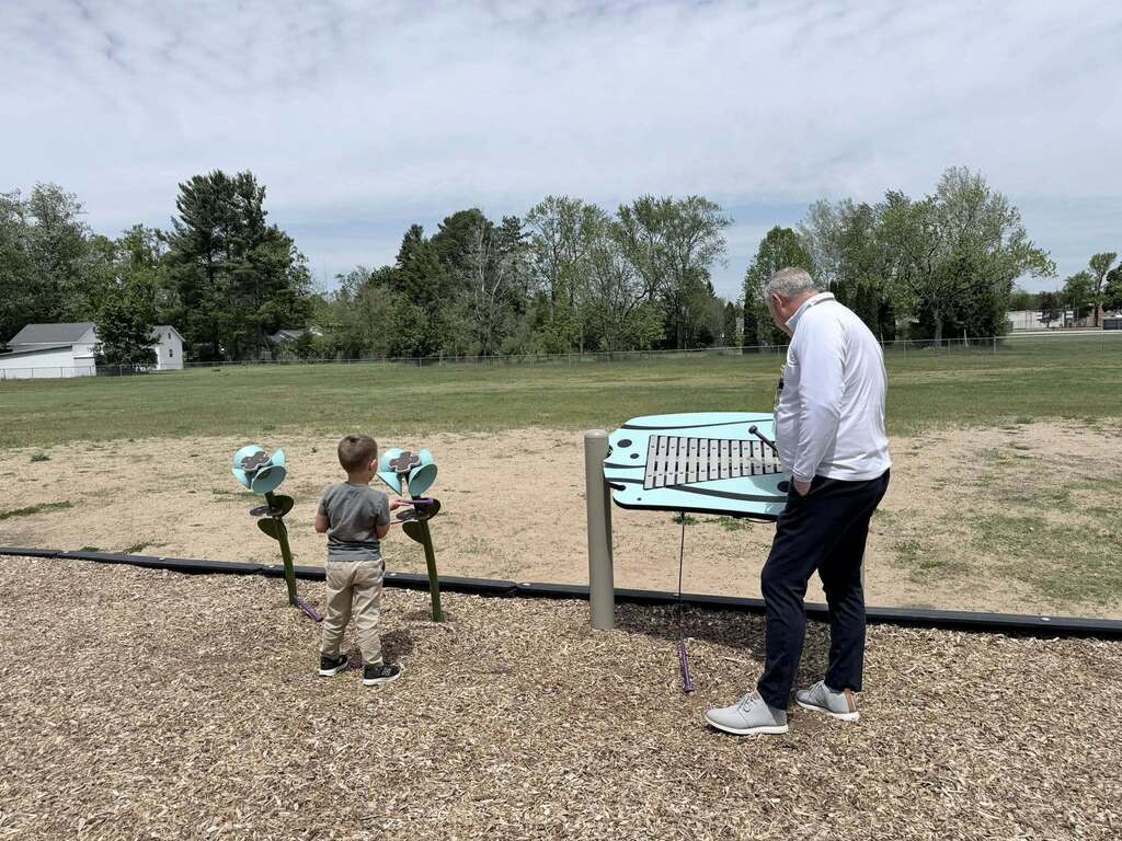 Mr. Biller, the Superintendent, playing with a student on the playground