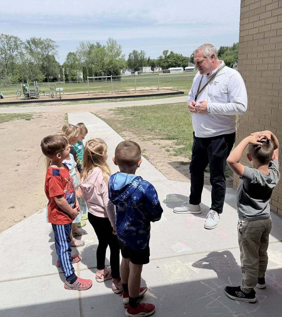 The Superintendent, Mr. Biller, talking with preschool students about how he can help improve their school.