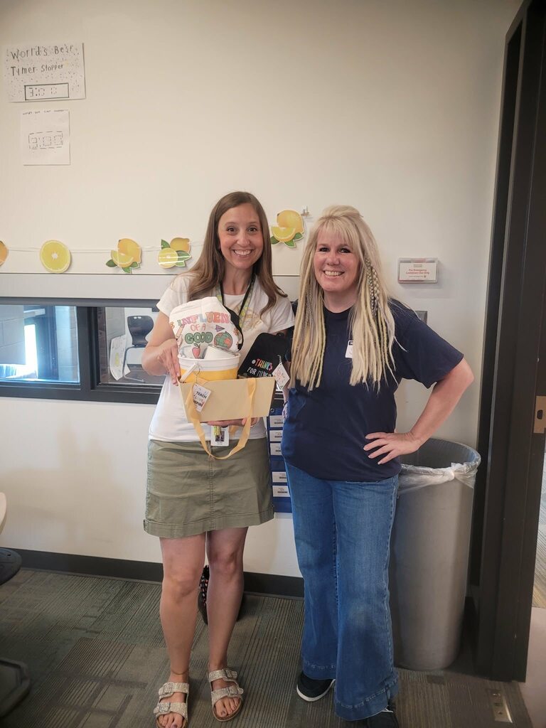 Mrs. Miller posing with a Wesco employees after winning a gift basket.