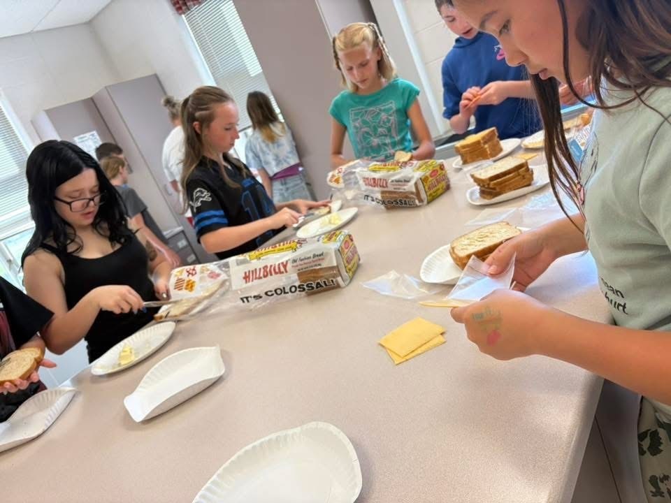 Students making sandwiches in culinary class. 