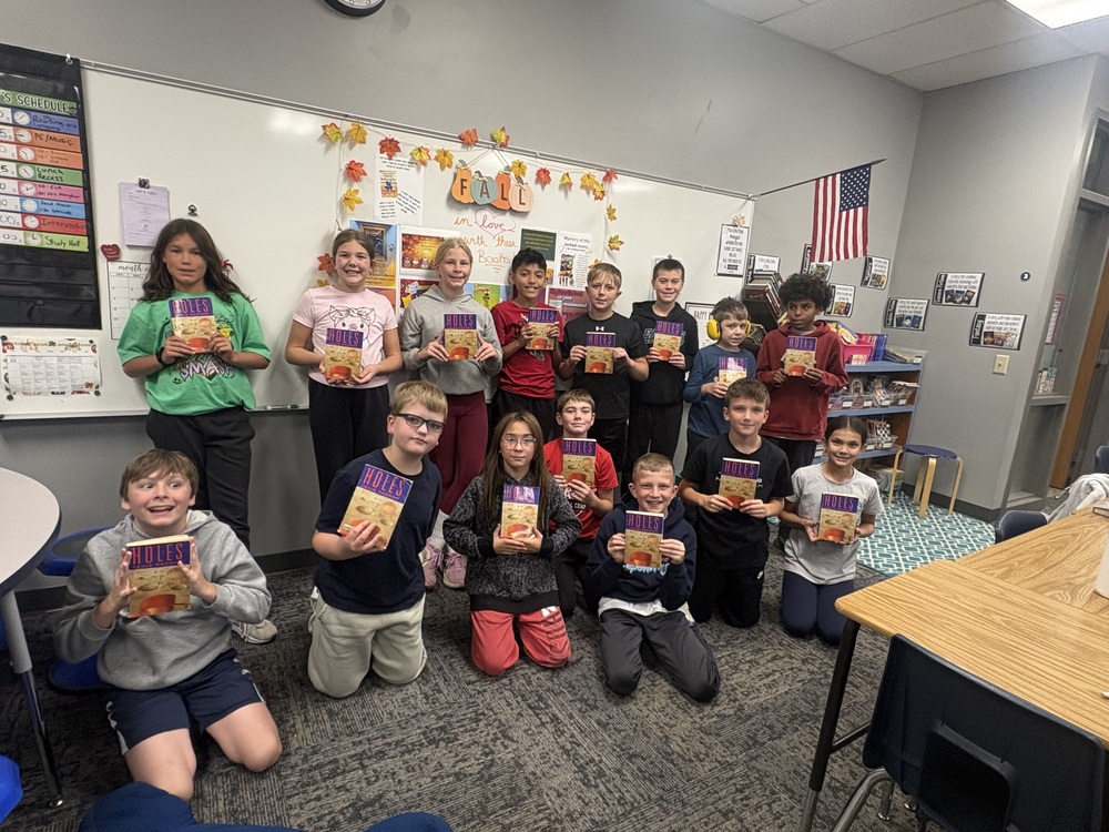 5O Class holding up their read aloud book