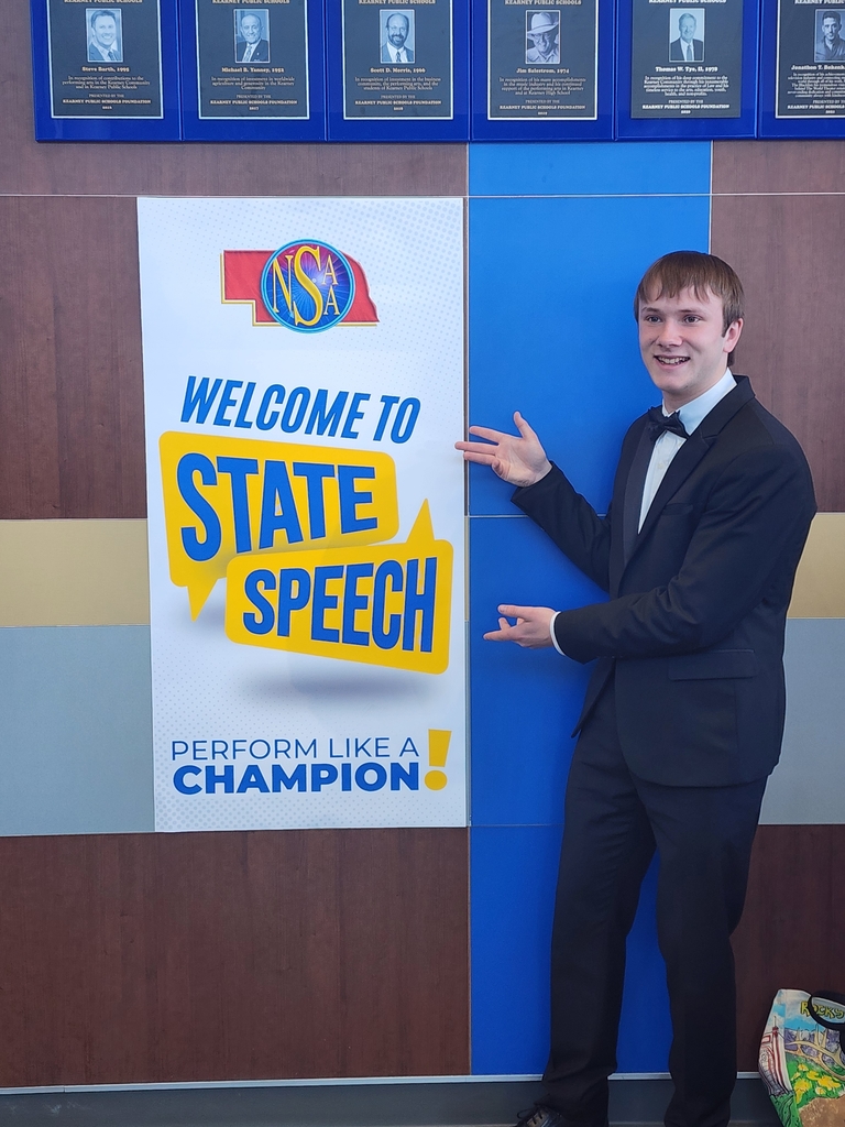 Ethan next to a State speech poster