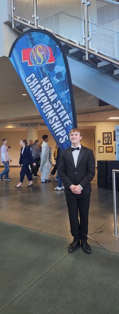 Ethan next to state speech flag