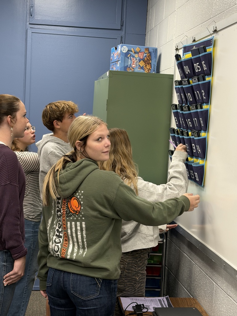 Students look for the key behind the calculator holder.