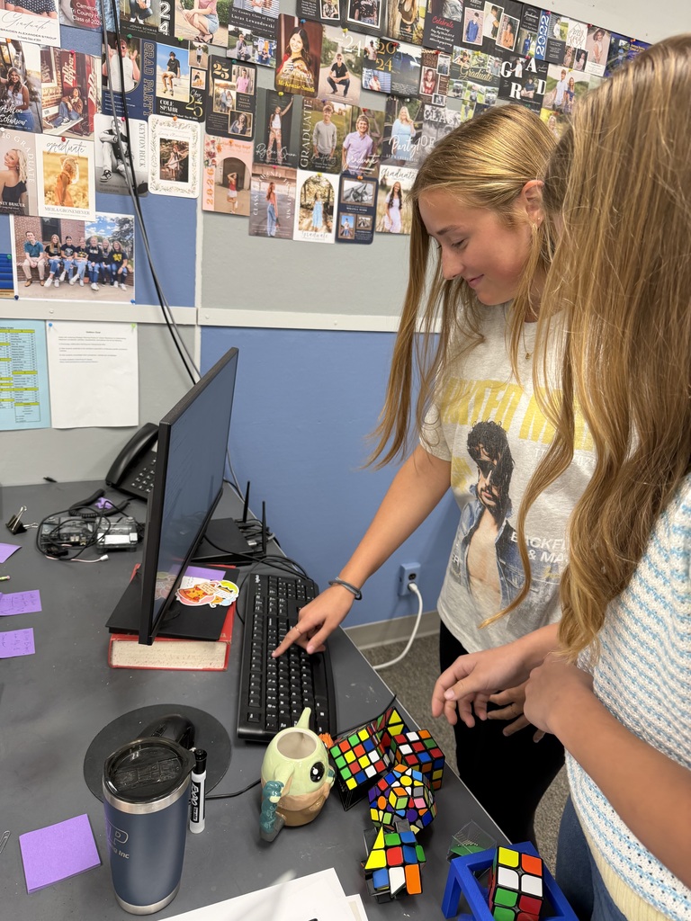 Students plugging in their answer from the activity into the computer to generate a hint for the escape room.
