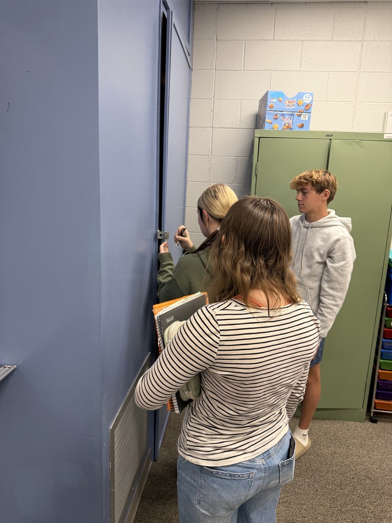 Students unlocking the cabinet for their prize.