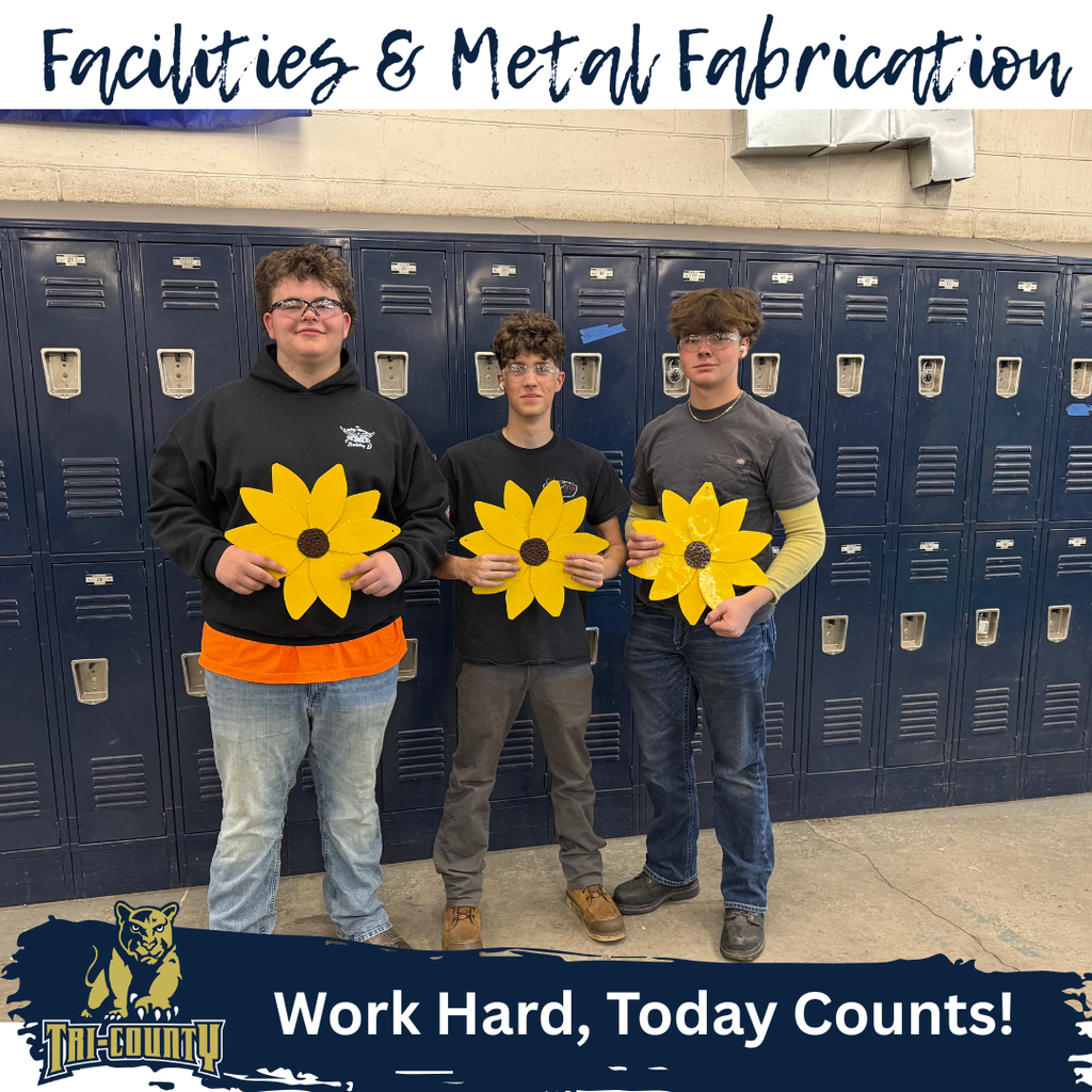 Facilities and Metal Fab Students with Metal Sunflowers
