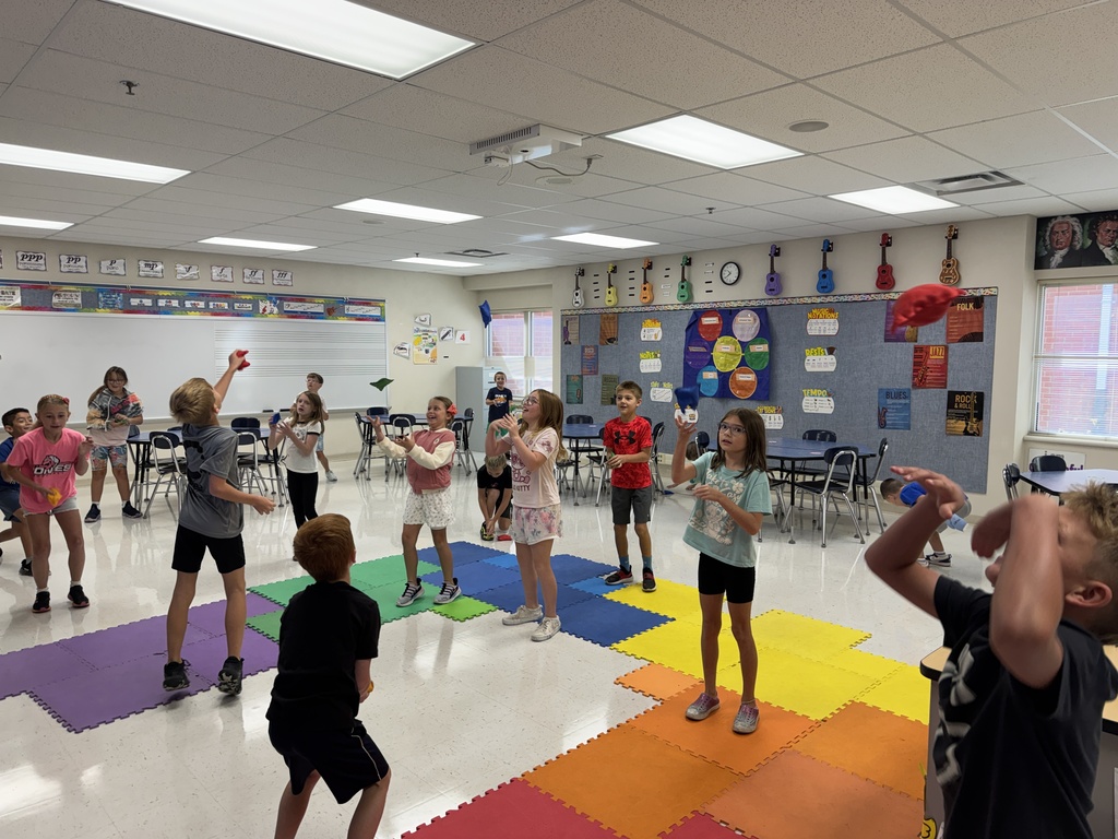Students practice musical accents using beanbags.