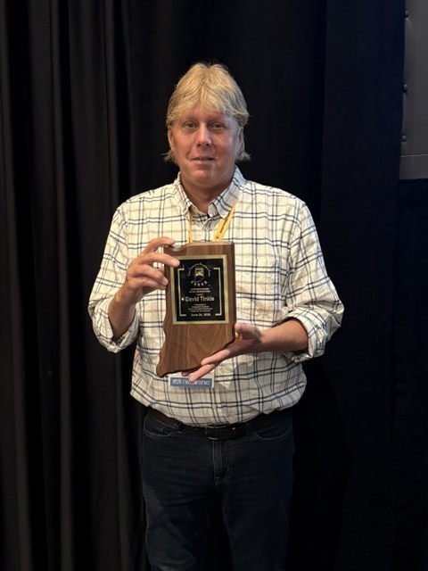 David Tinkle holding award