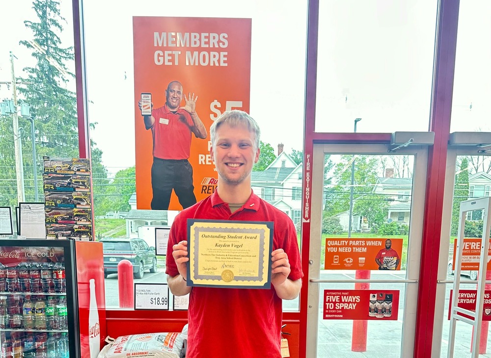 Student holding certificate at AutoZone