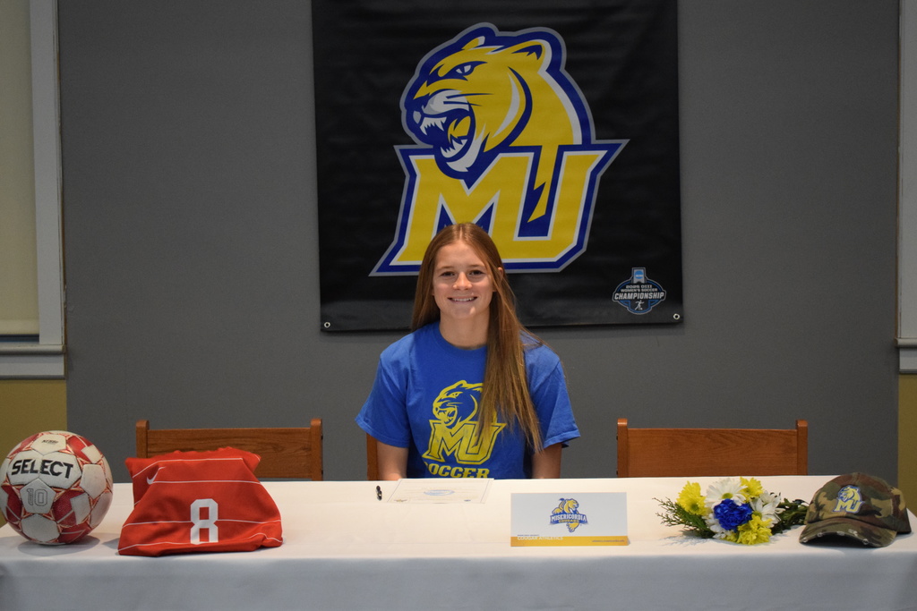 Student at signing table