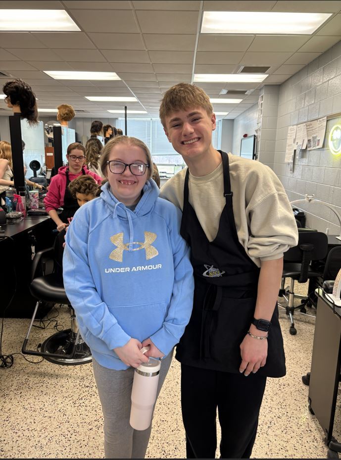 Two students smiling at Camera