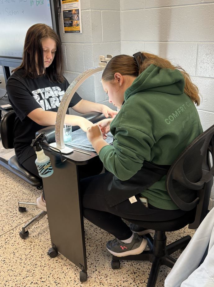 student receiving a manicure