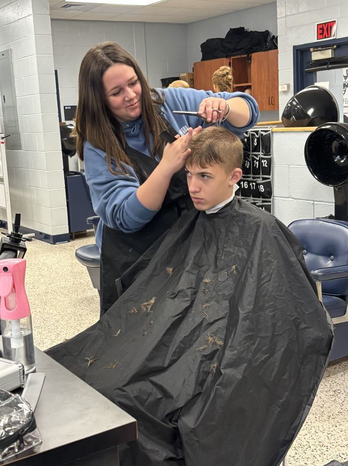 Student receiving a haircut