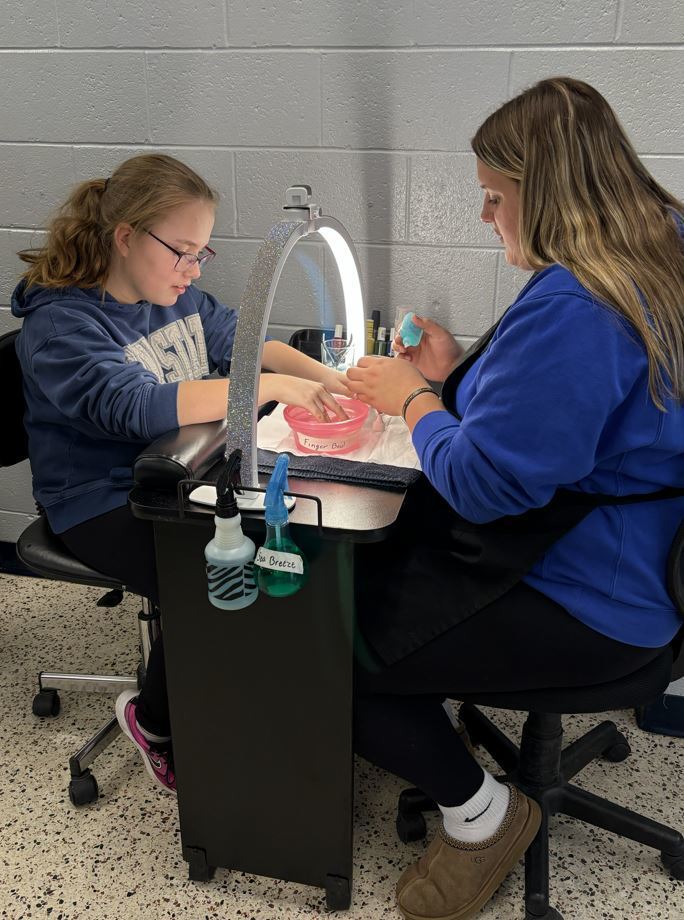 student receiving a manicure