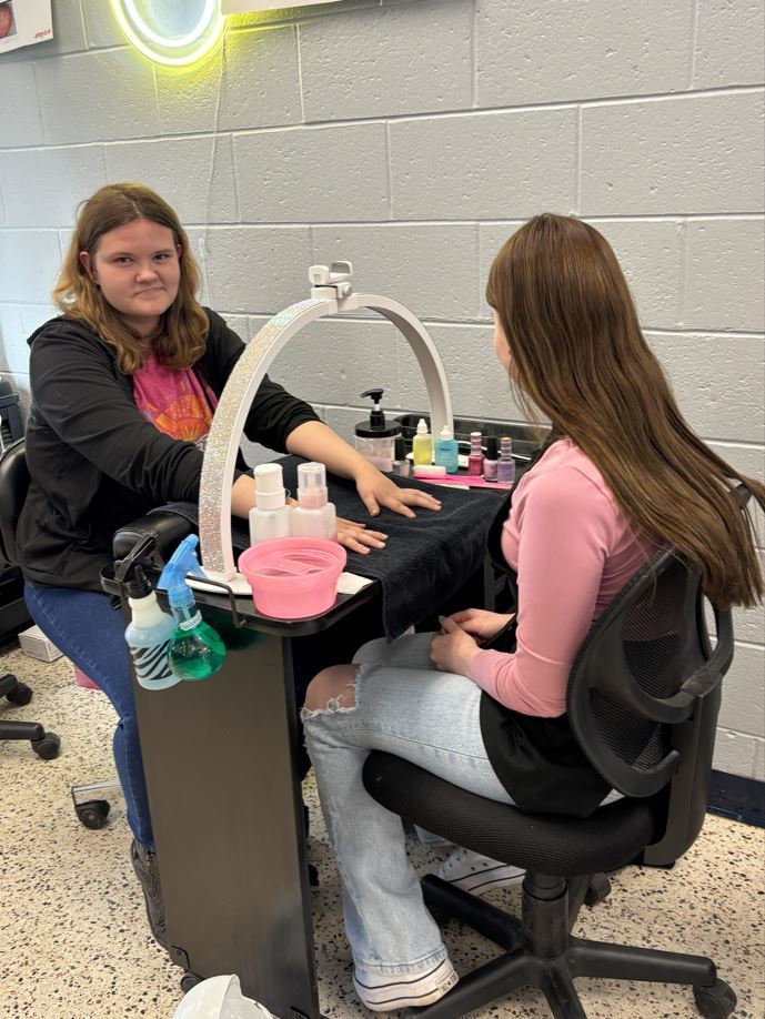 student receiving a manicure