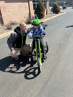 student and principal with adaptive bike