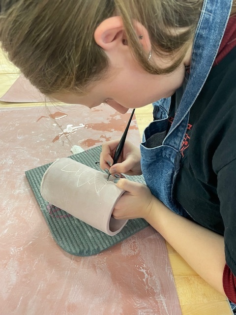 Student practicing sgraffito technique