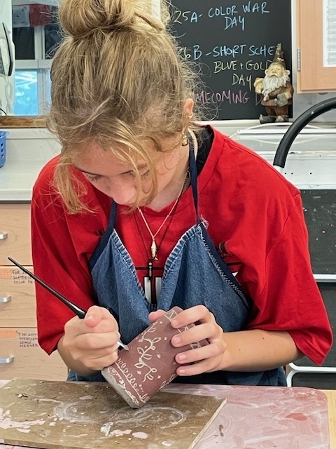Student practicing sgraffito technique