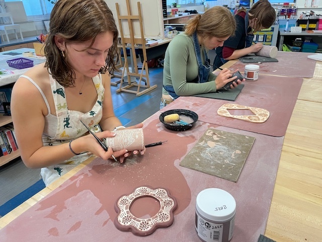 Students practicing sgraffito technique