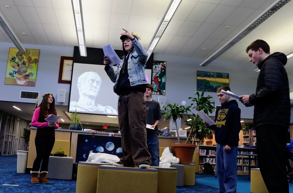 Students giving speeches in a theater adaptation