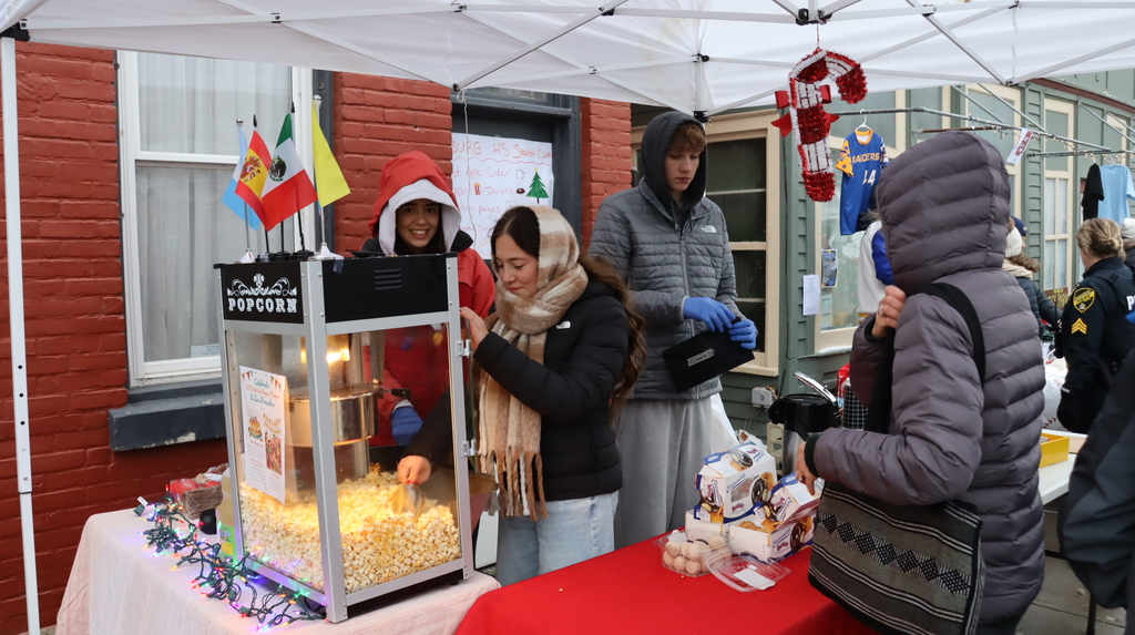 Students making popcorn at the Spanish club table
