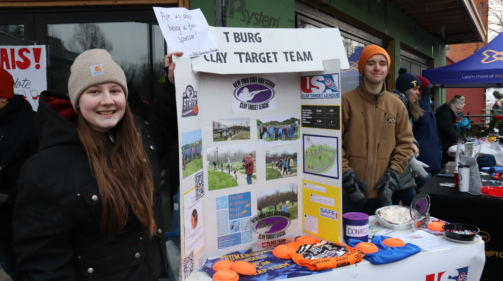 Students with a poster for the clay target team