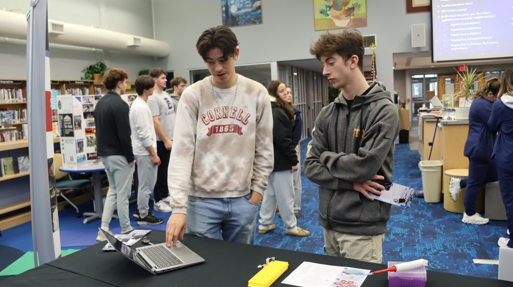 Students looking at a computer at the New Visions event