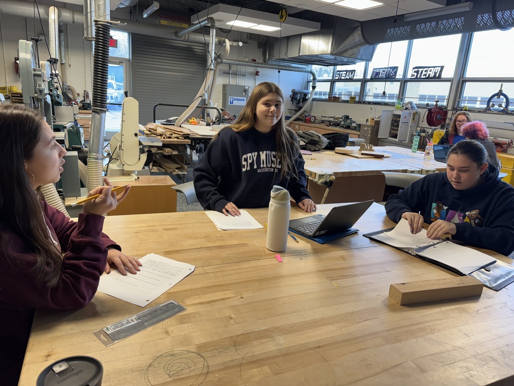 Students brainstorm  around a table