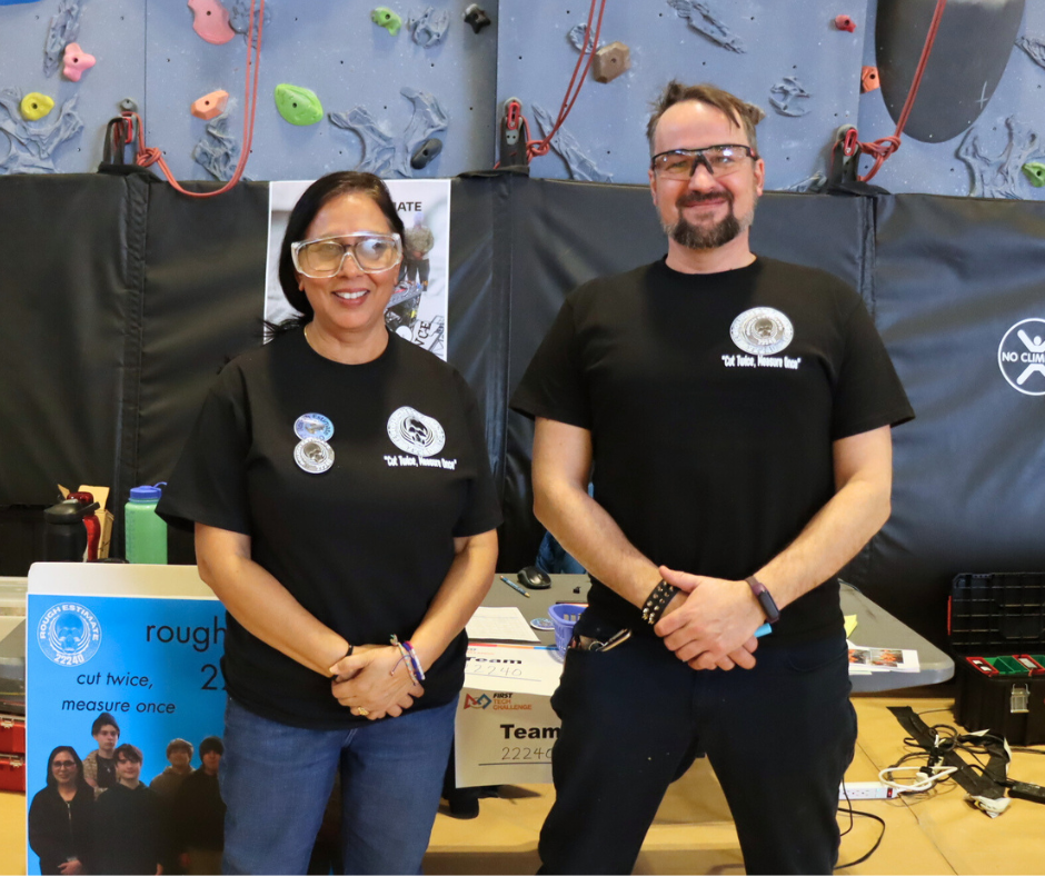 Staff advisor and STEAM teacher look on