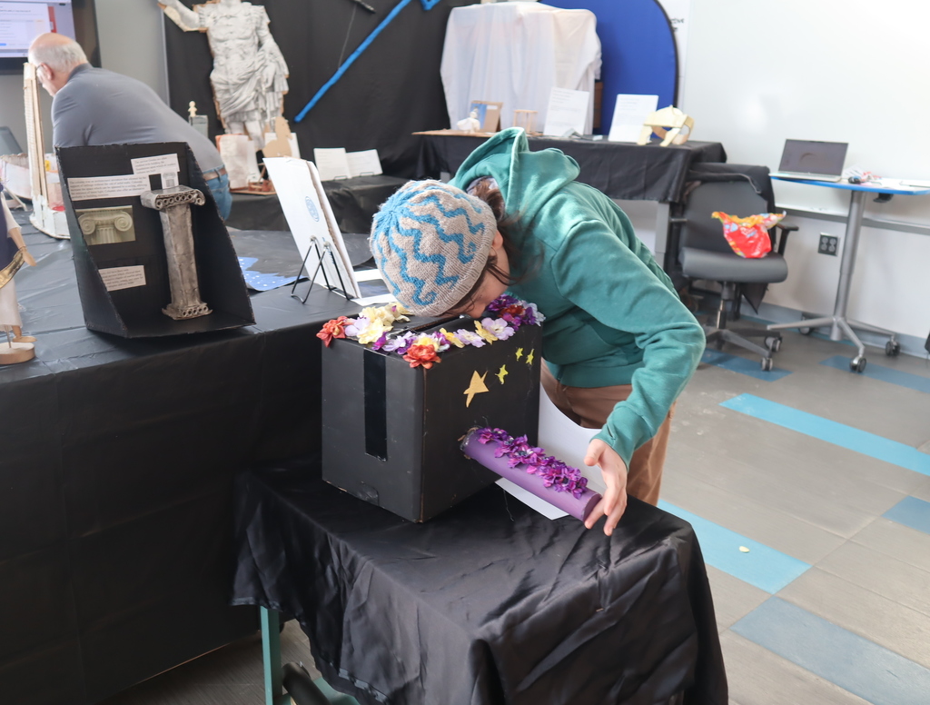 Middle School students looking at student projects for STEAM.