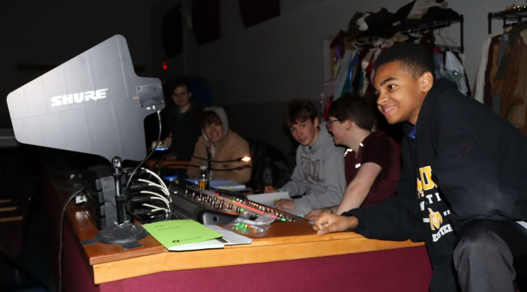 Students working the lights and sounds board