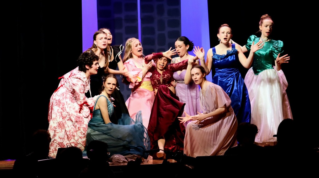 Girls in bright dresses dancing and singing