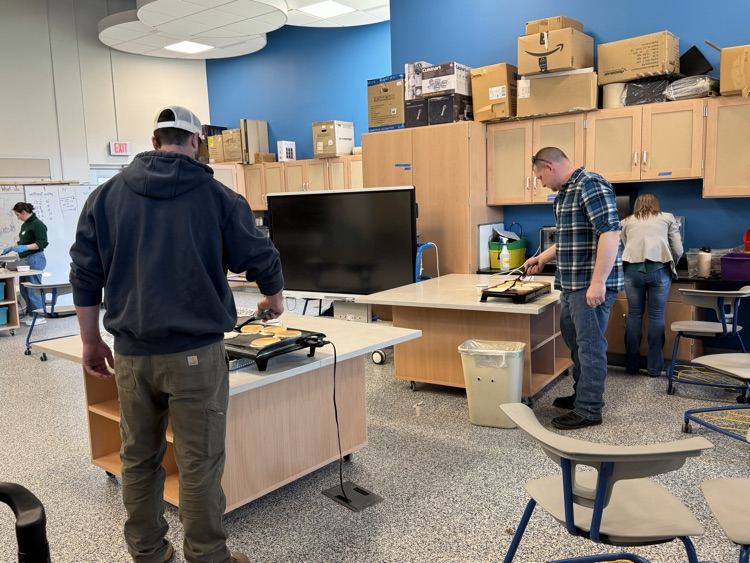 parent volunteers making pancakes 