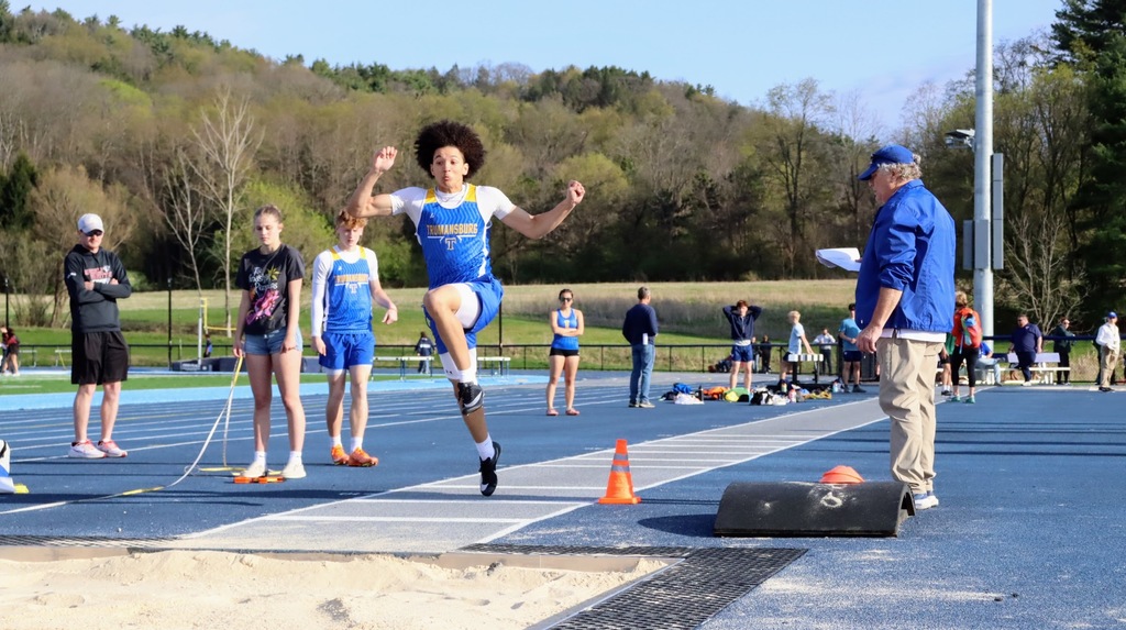 A student is getting ready to leap into a long jump