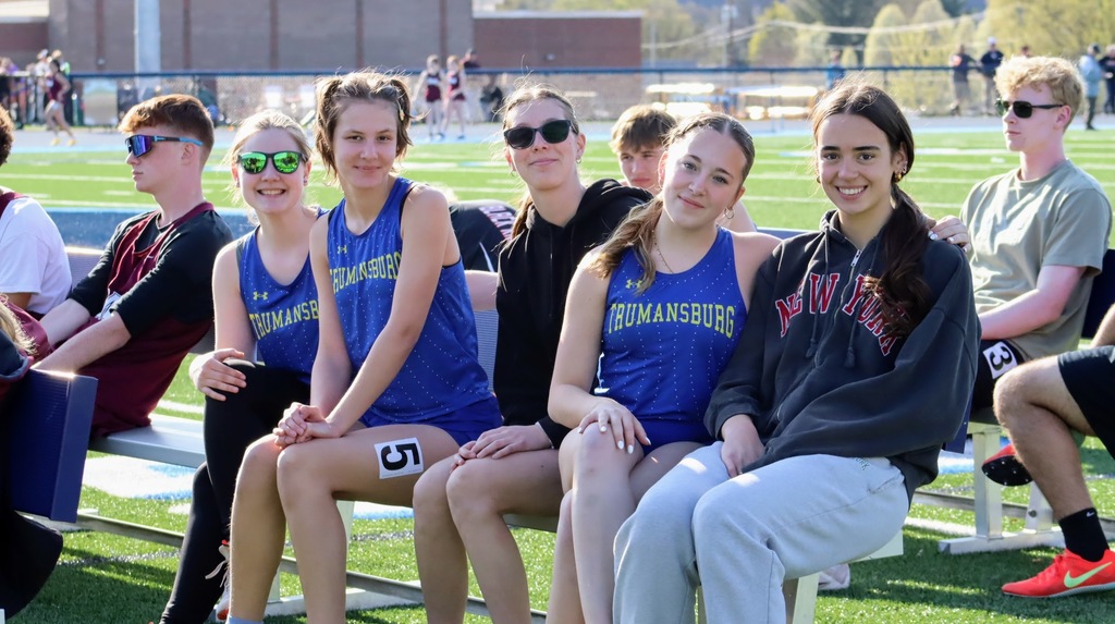 Students smiling and sitting