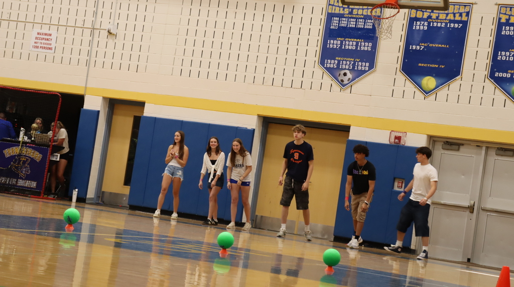 Students line up in the gym looking at dodge balls
