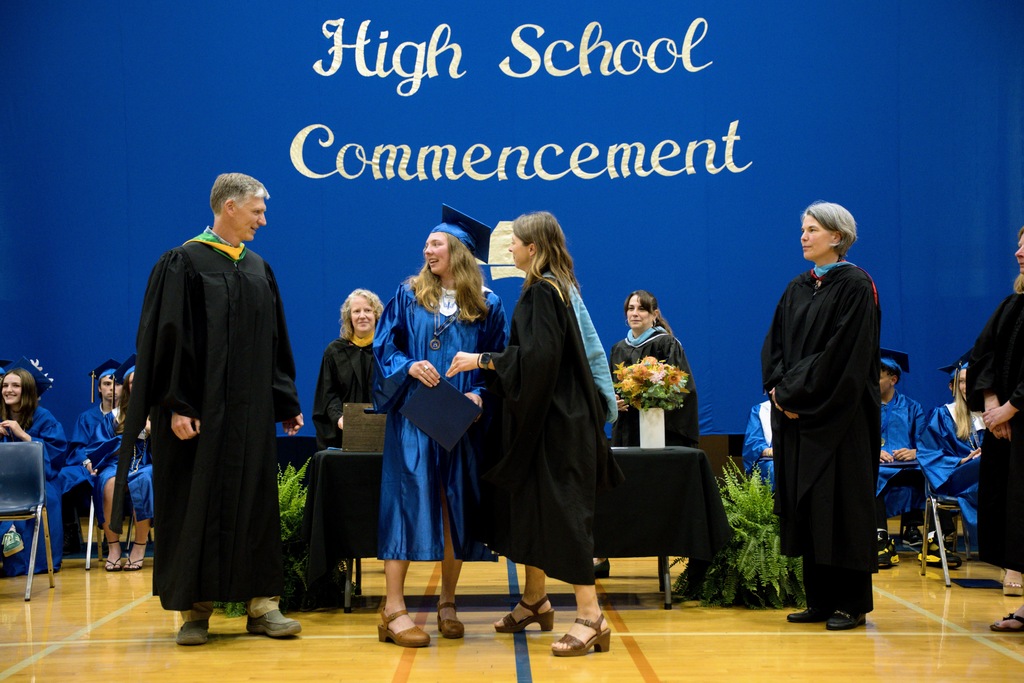 Student receiving a diploma from faculty 