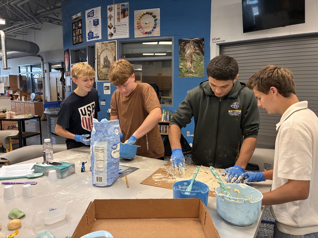 students with globes molding and mixing salt dough