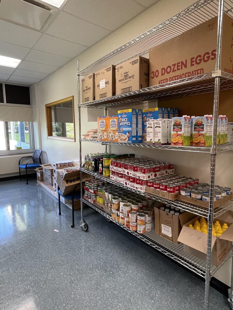 Metal shelves with canned goods and other food