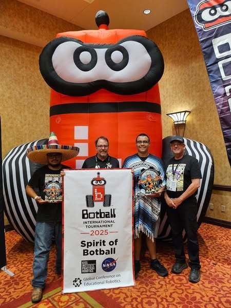 students posing with botball awards