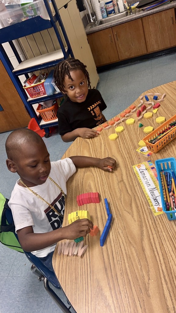 variety of colors and shape of bears, squares, and different objects used for counting, students, desk, classroom