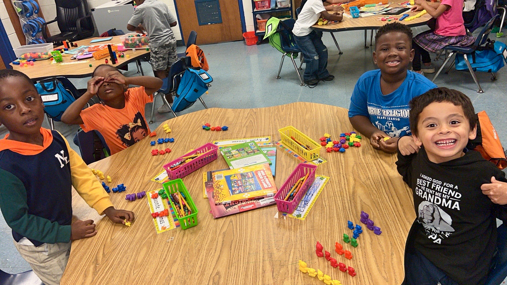 variety of colors and shape of bears, squares, and different objects used for counting, students, desk, classroom