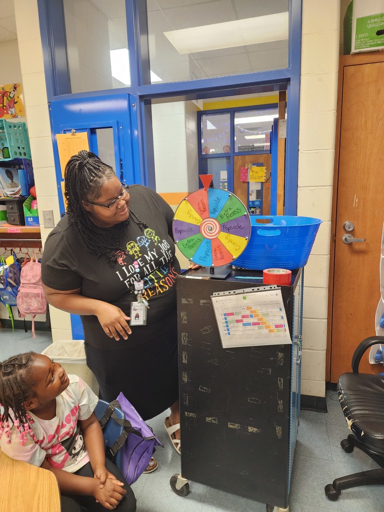 teacher, classroom door, windows, students, spinning wheel, cart