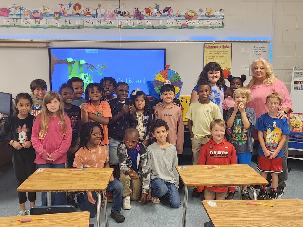 students, adults, board, classroom decorations, spinning wheel