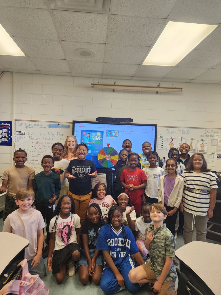 students, adults, board, classroom decorations, spinning wheel