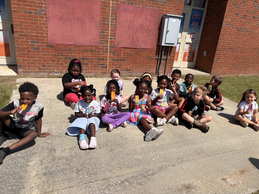 students, popsicles, brick building, concrete
